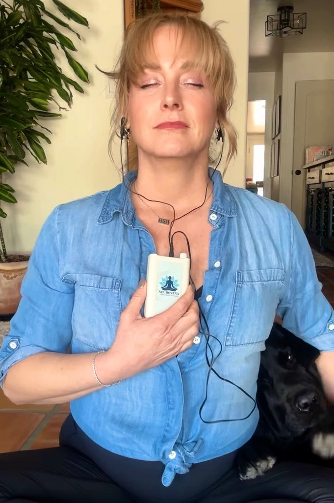 Midlife woman using Neurovana CES Therapy device at home for anxiety relief and nervous system calm